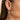 Purple freshwater pearl earrings worn on ear