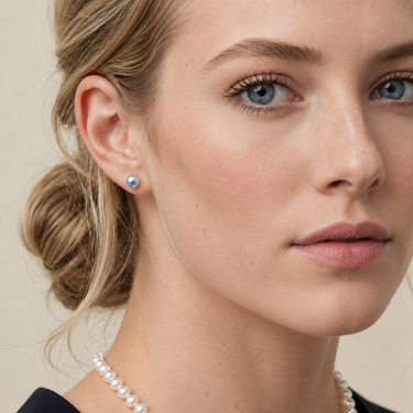 Model wearing 6-7mm blue Akoya round pearl stud earrings.