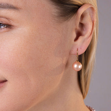 Close-up of 12-13mm natural pink freshwater pearl fish hook earrings