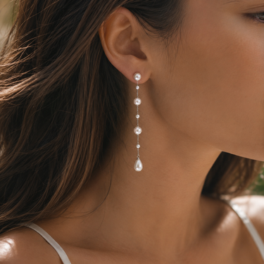 Model wearing white freshwater pearl cascade drop earrings 